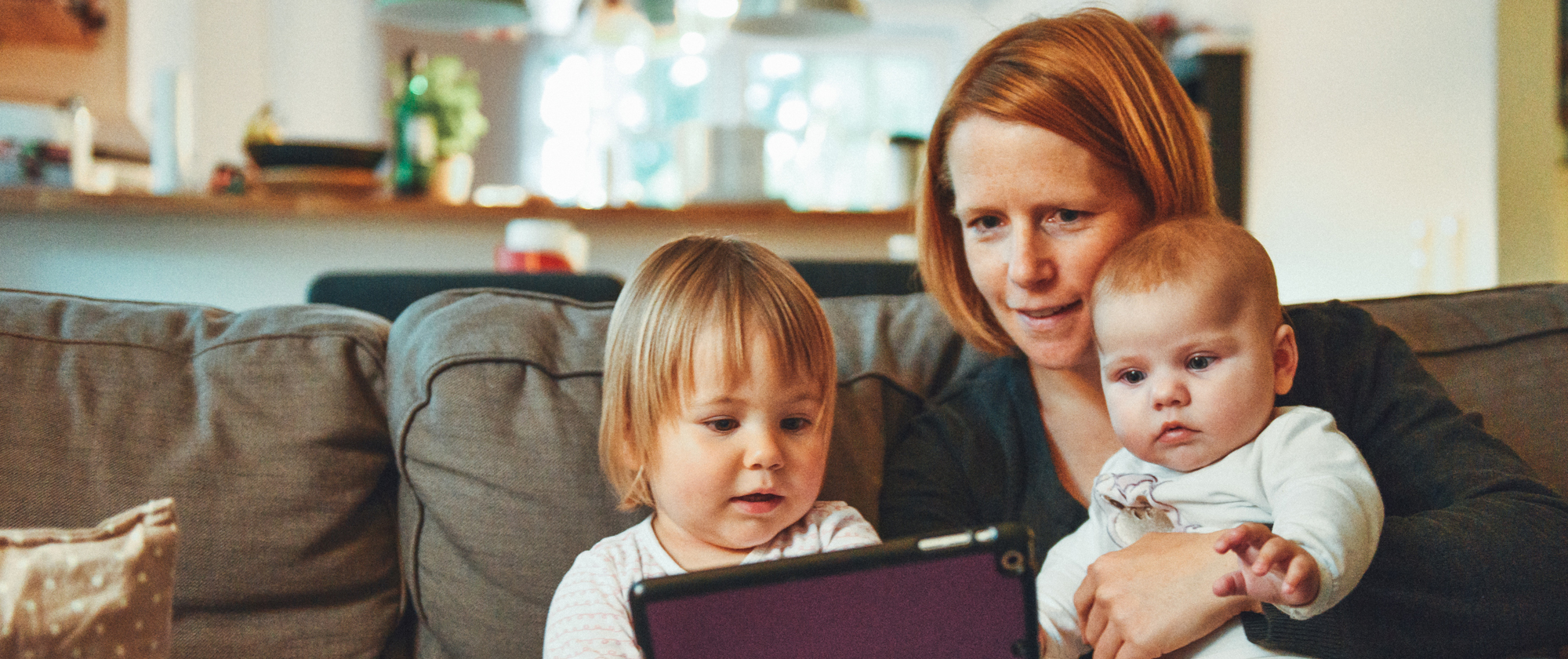 Mother and children looking at tablet